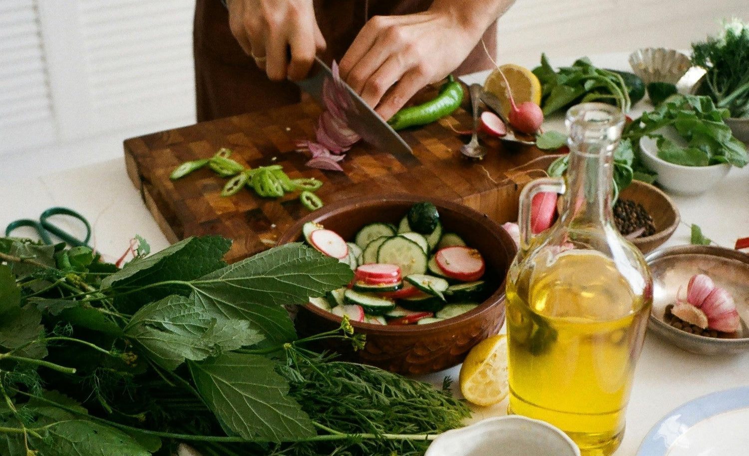 Savor the Unexpected: 5 Regenerative Ways to Enjoy Organic Green Tea, image of greens being cut on a cutting board