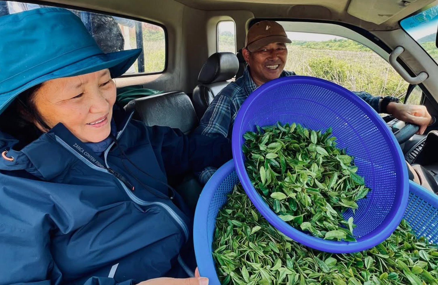 Blog: Listening to the Land: How Our Farmers Connect with Every Leaf, image of farmers with tea leaves