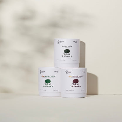 Organic green tea matcha powder in its recyclable paper container by Wild Orchard, image of variety of matcha teas