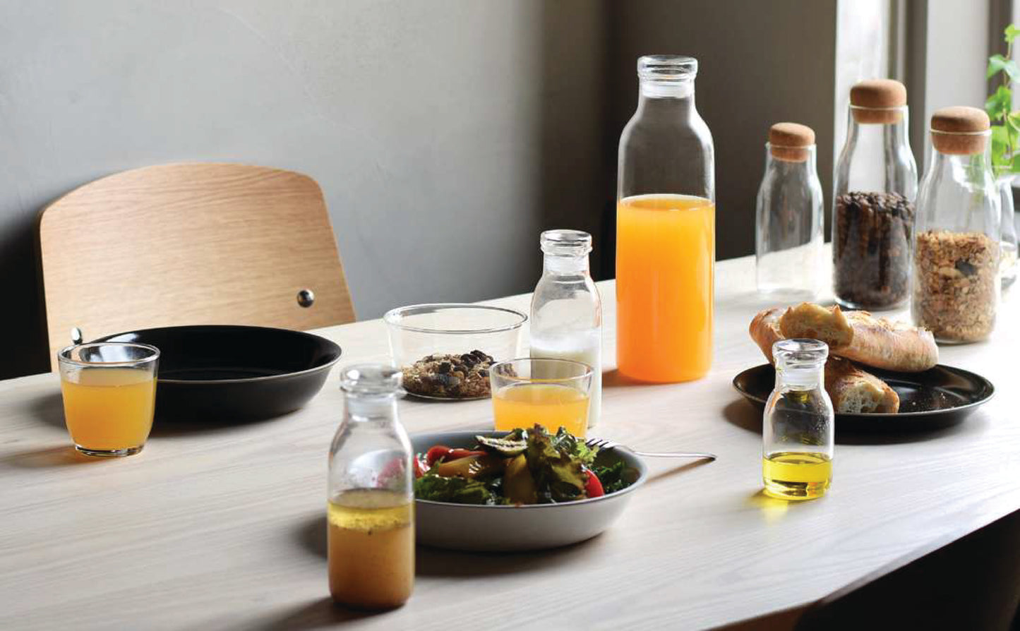 KINTO Glass Carafe with Glass Lid offered by Wild Orchid Tea, image of carafe set on a table