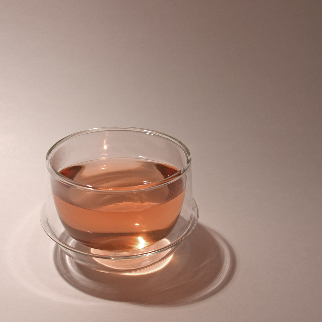 Rose Green Tea - Loose Leaf by Wild Orchard Tea, image of brewed tea in a glass cup