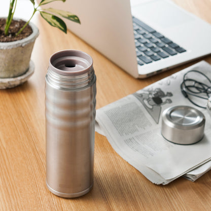 KYOCERA Ceramic Coated Twist Top Thermos offered by Wild Orchard Tea, image of thermos on a desk