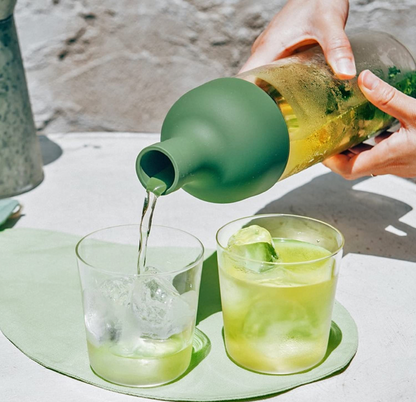 HARIO Cold Brew "Wine" Bottle at Wild Orchard Tea, olive green top, image of serving cold tea
